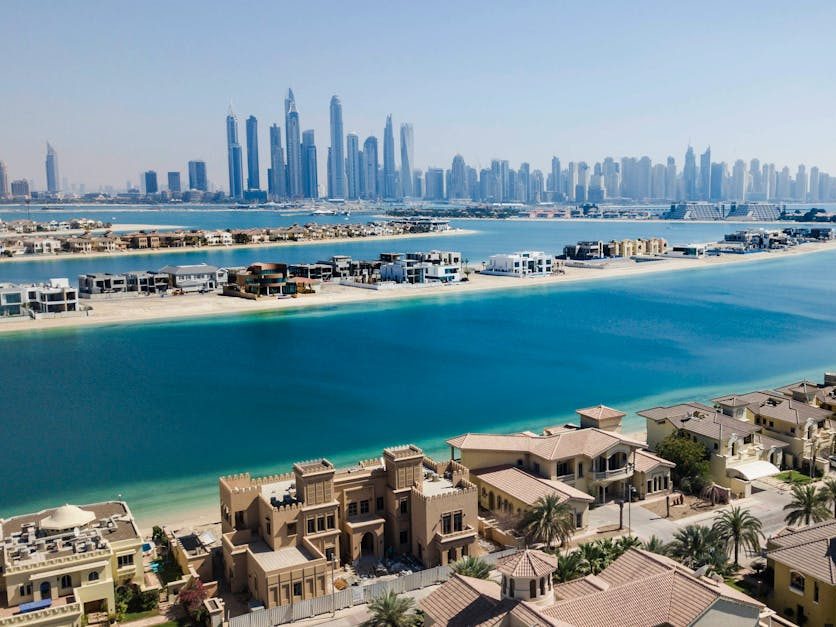 A breathtaking aerial view of Dubai's skyscrapers and luxury villas on a sunny day.